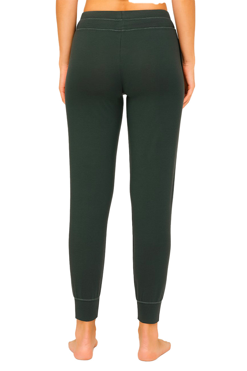 Rearview of spruce colored joggers worn by a woman on a white 