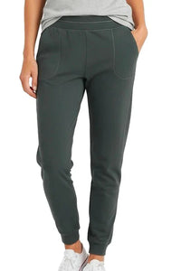 Dark green cotton jogger pants with pockets and a relaxed fit, worn with white sneakers