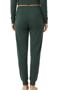 Back view of woman wearing dark green Pima cotton jogger loungewear pants