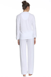 Woman in white long sleeve loungewear pajama set, back view, barefoot