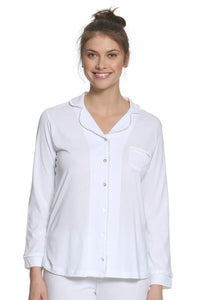 Woman wearing white long sleeve Pima cotton pajama top with button front and pocket
