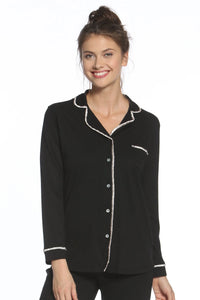 Woman wearing black long sleeve pajama top with white piping, button front, loungewear