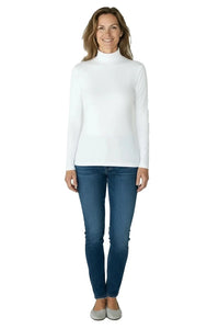 Smiling woman wearing white turtleneck long-sleeve shirt with blue jeans and gray flats