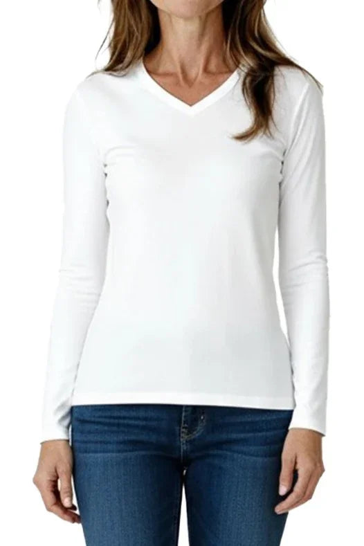 Woman wearing white long-sleeve V-neck shirt paired with blue jeans on white background