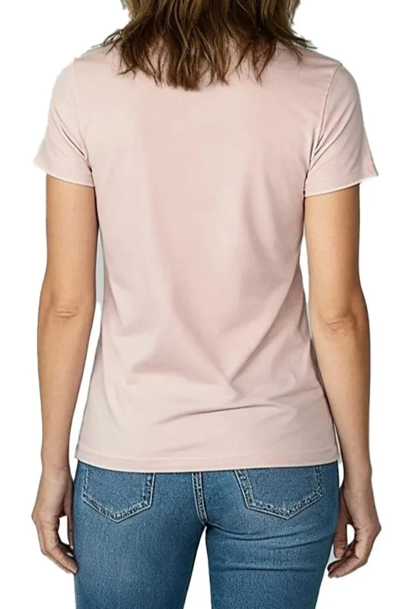 Woman wearing shell pink short sleeve t-shirt paired with blue denim jeans, back view