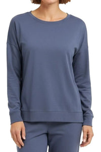 Woman wearing steel blue long-sleeve crewneck sweatshirt and matching pants