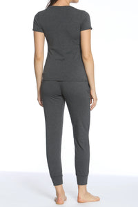Back view of woman wearing heather charcoal gray short sleeve top and jogger pants loungewear set barefoot