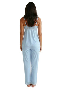 Woman wearing light blue chambray pajama set with lace trim, back view on white background