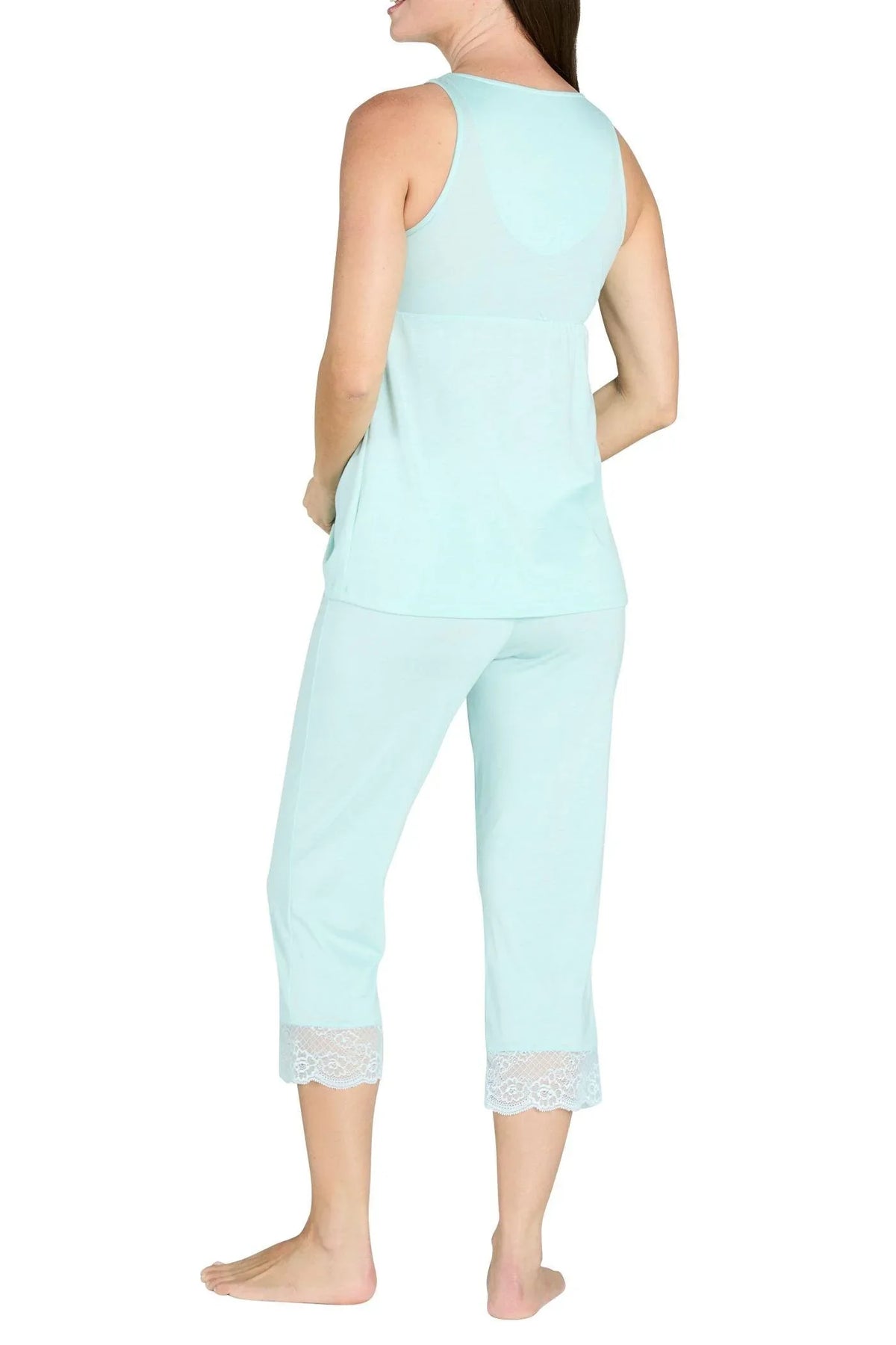 Woman in light blue sleeveless tank top and cropped pants with lace trim on white background
