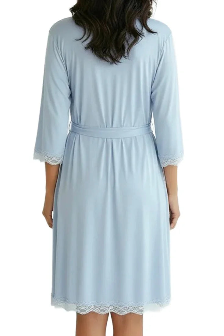 Back view of woman wearing light blue knee-length robe with lace trim and belt
