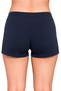 Back view of woman wearing solid midnight blue fitted athletic shorts on white background