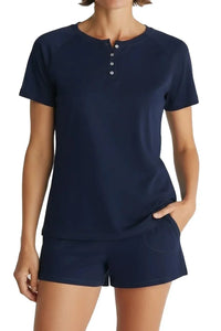 Woman wearing navy blue short sleeve henley shirt and matching boxer shorts with pockets