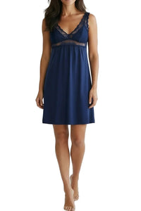 Woman wearing indigo blue lace-trimmed sleeveless nightdress on white background