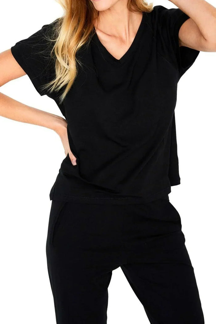 Woman wearing black short sleeve pullover lounge top and matching pants